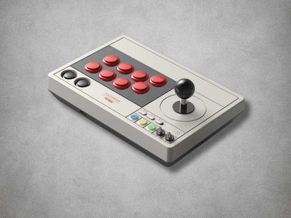 8BitDo Arcade stick with red buttons and joystick on a grey background side view