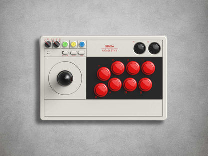 8BitDo Arcade stick with red buttons and joystick on a grey background