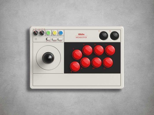 8BitDo Arcade stick with red buttons and joystick on a grey background