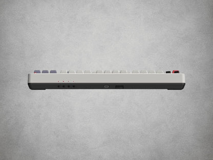 8BitDo Mechanical Keyboard NES with red and grey keys on a grey background Top View