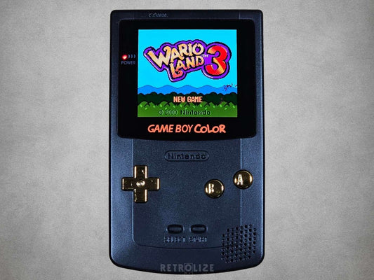 Nintendo Game Boy Color Black and Gold displaying 'Wario Land 3' on a grey background