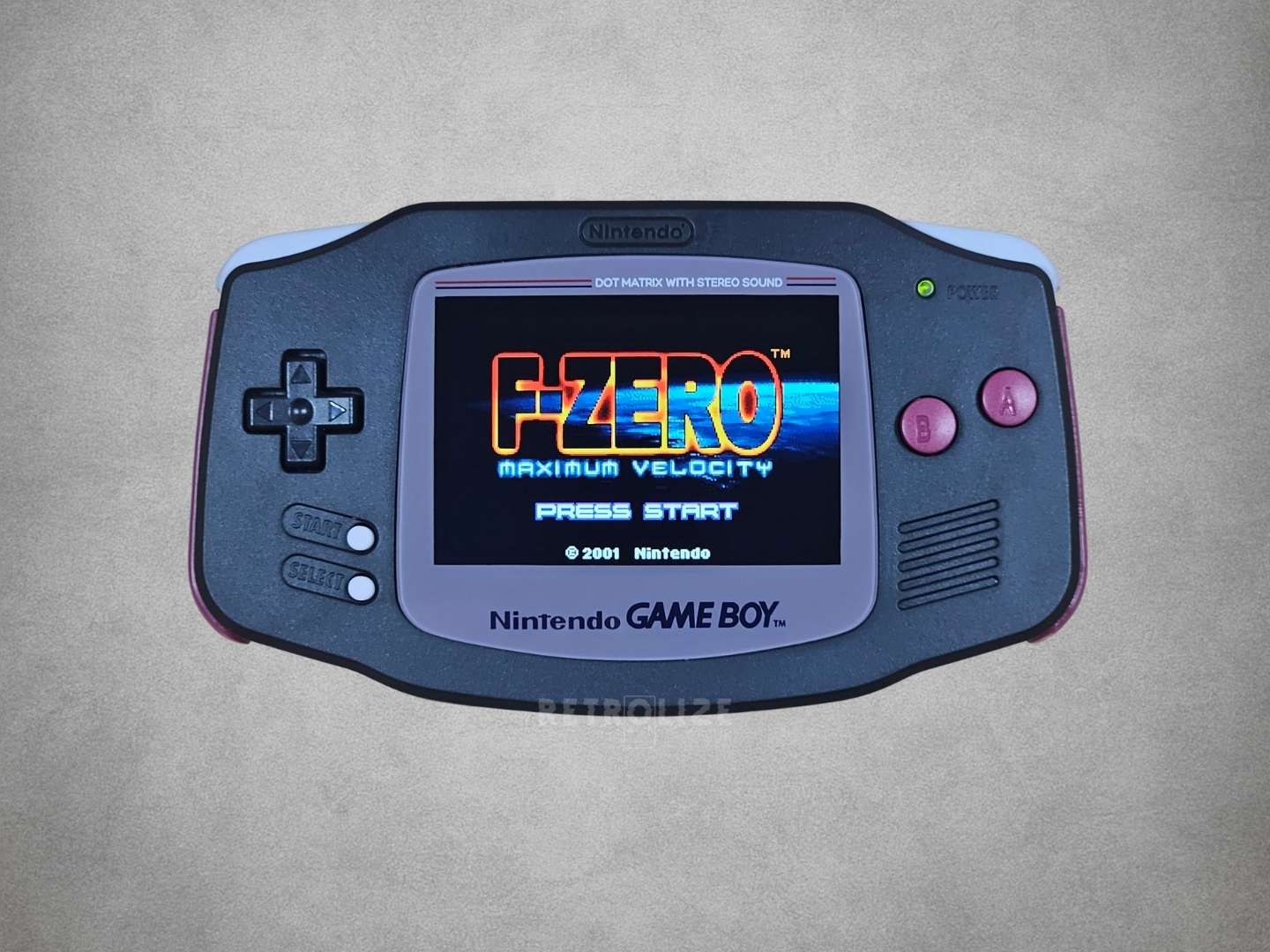 Nintendo Game Boy Advance displaying the title screen of 'F-Zero' on a grey background