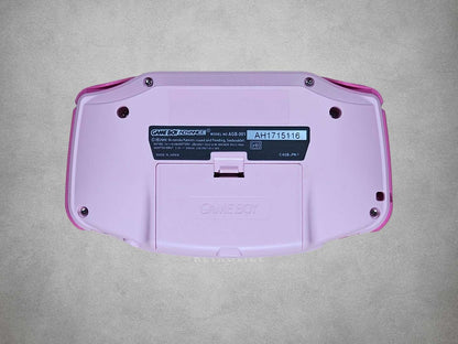 Pink Game Boy Advance with Hot Pink buttons on a grey background Back View