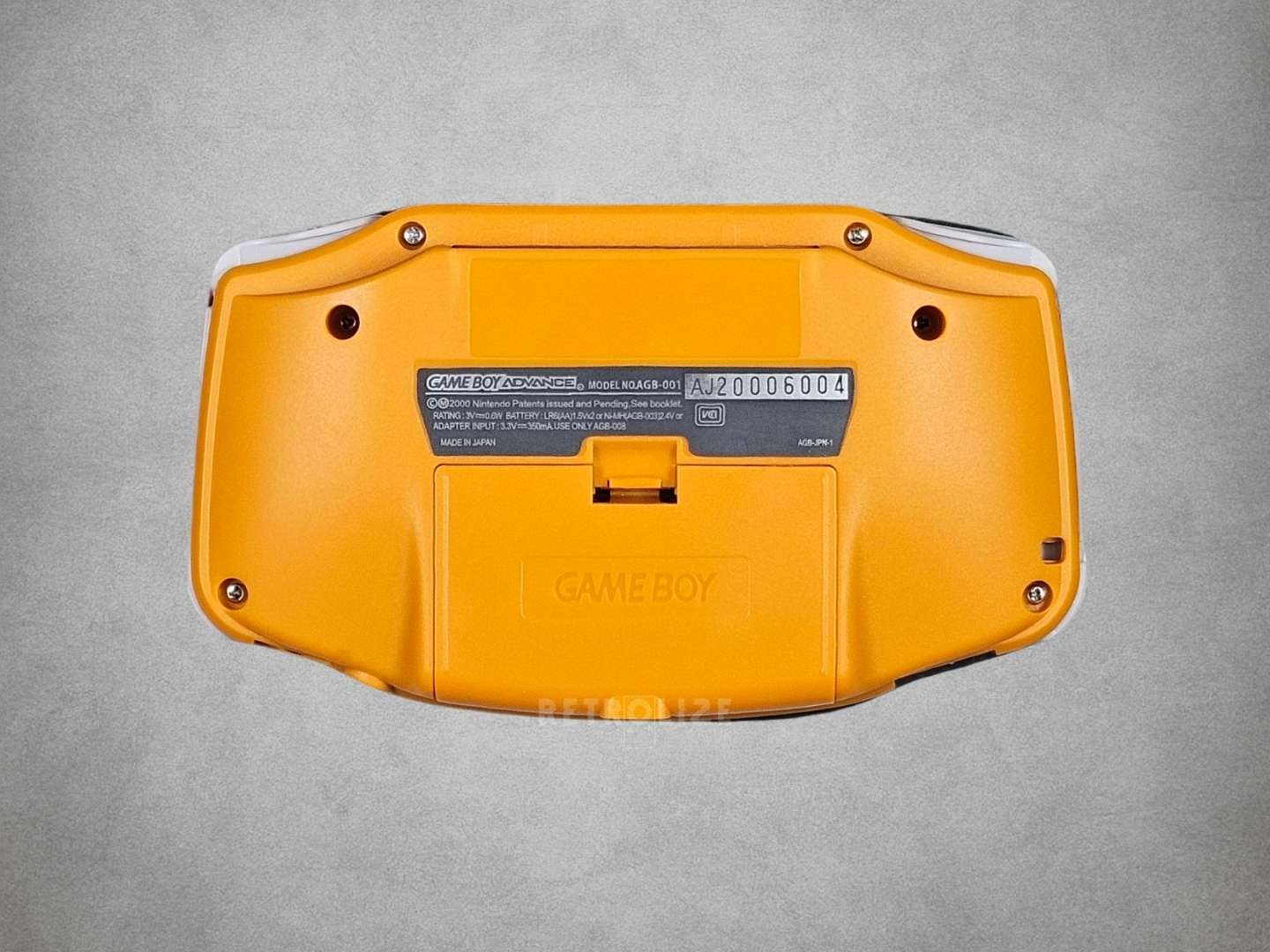 Spice Orange Game Boy Advance back view grey background