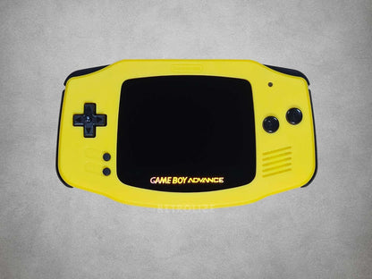 Yellow Game Boy Advance console on a grey background
