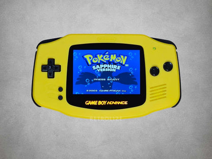 Yellow Game Boy Advance displaying 'Pokémon Sapphire Version' on a grey background
