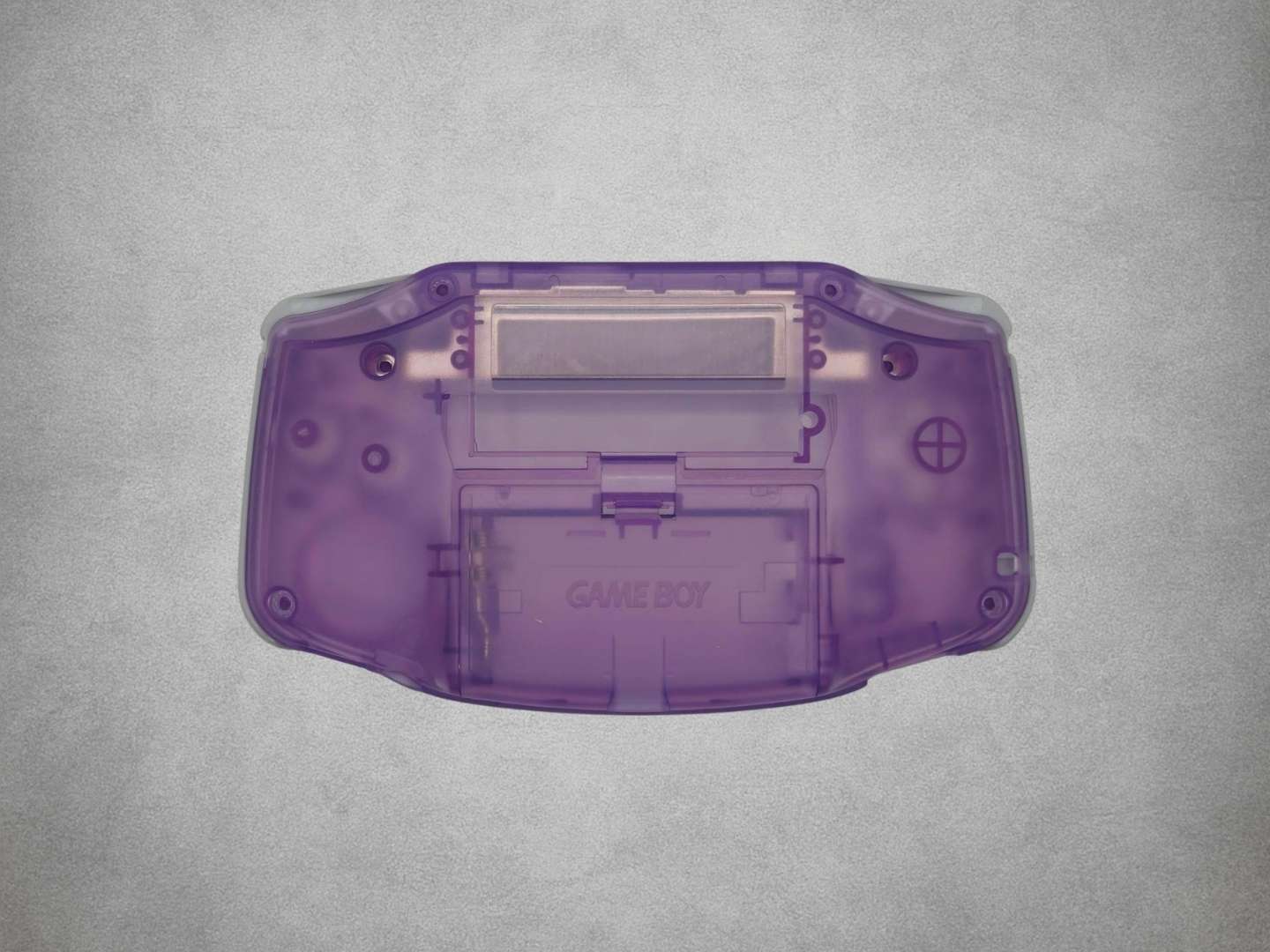 Atomic Purple Game Boy Advance shell back on grey background