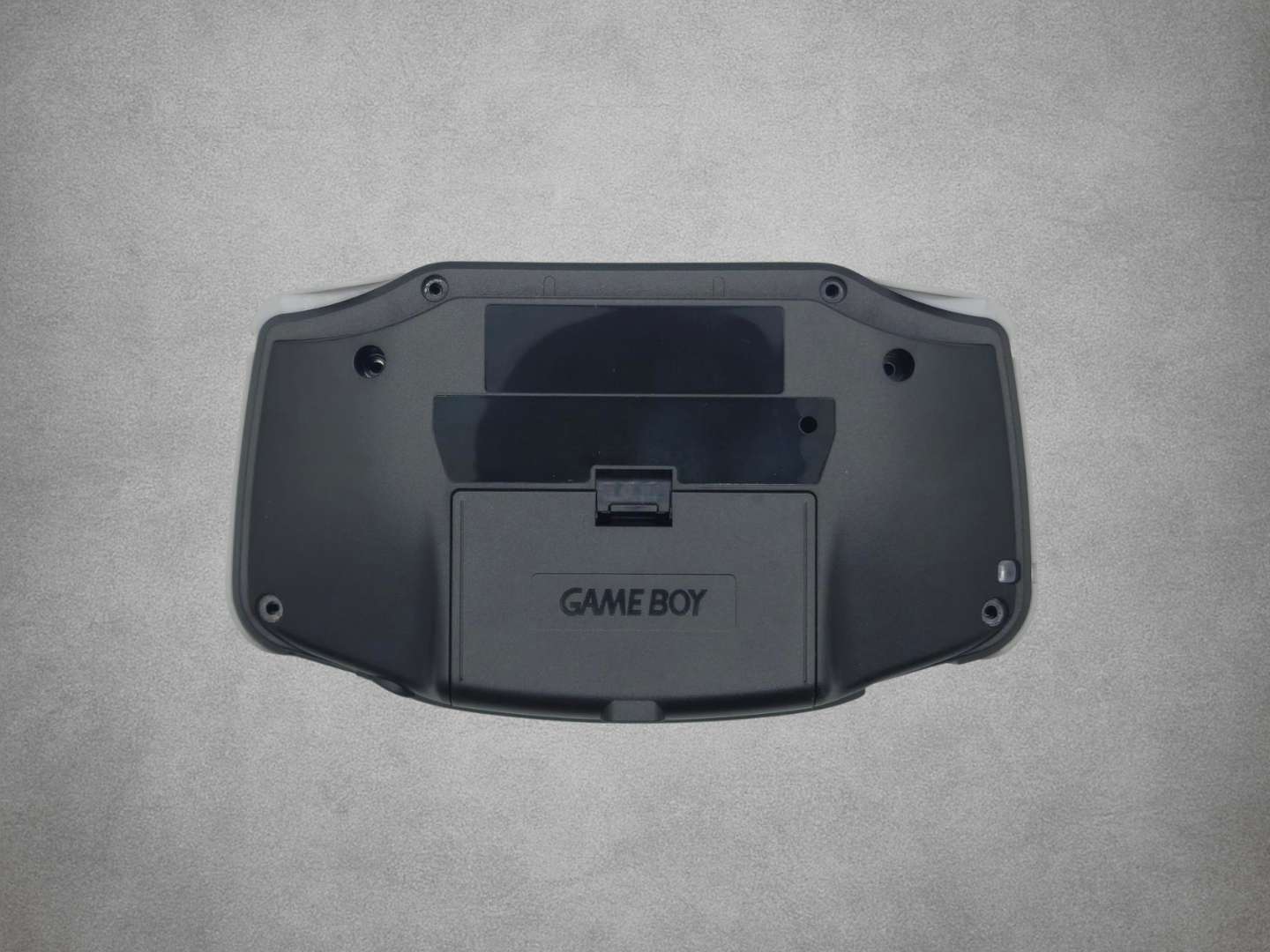 Smokey Black Game Boy Advance shell on grey background back