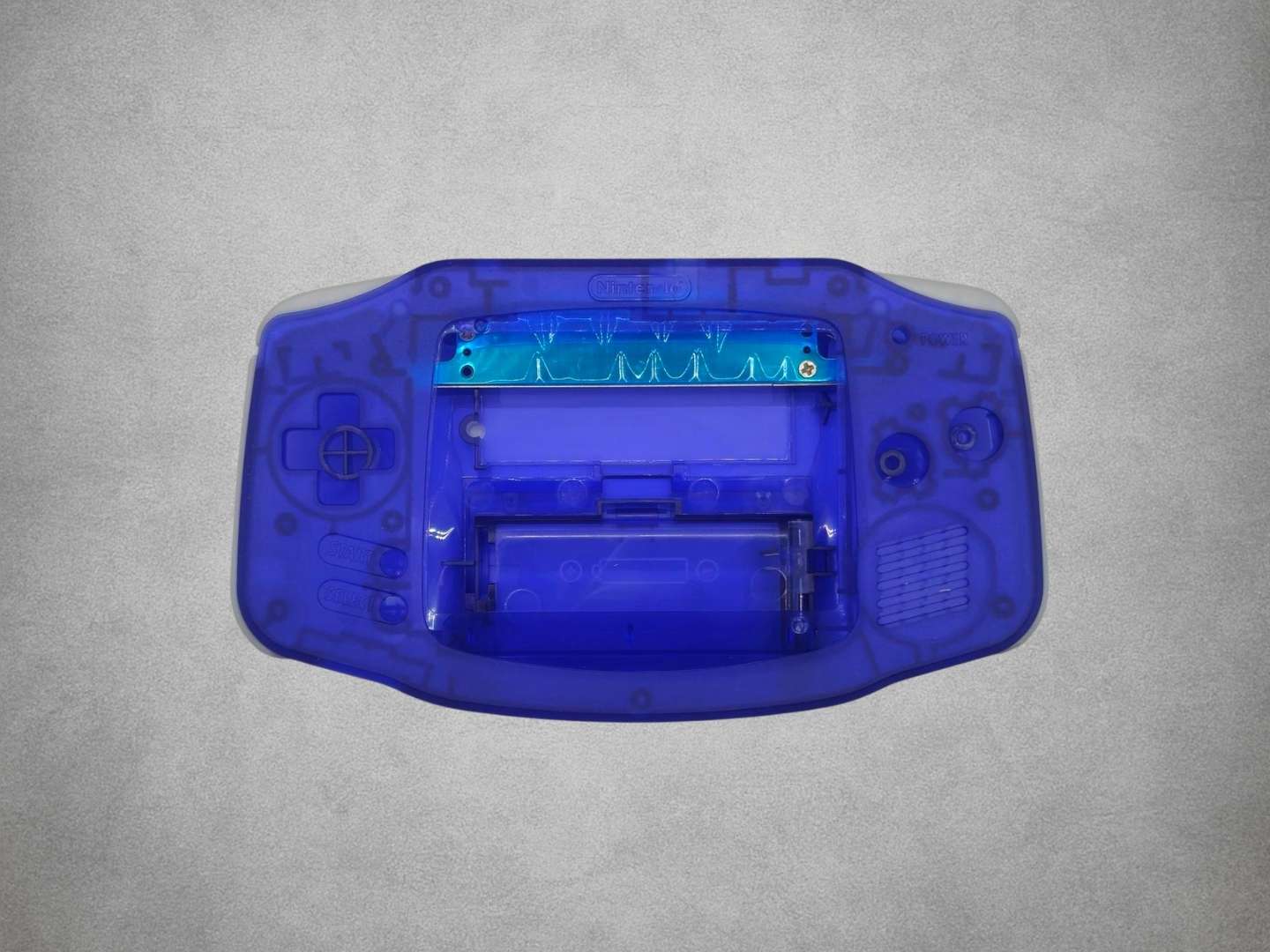 Clear Blue Game Boy Advance shell on grey background