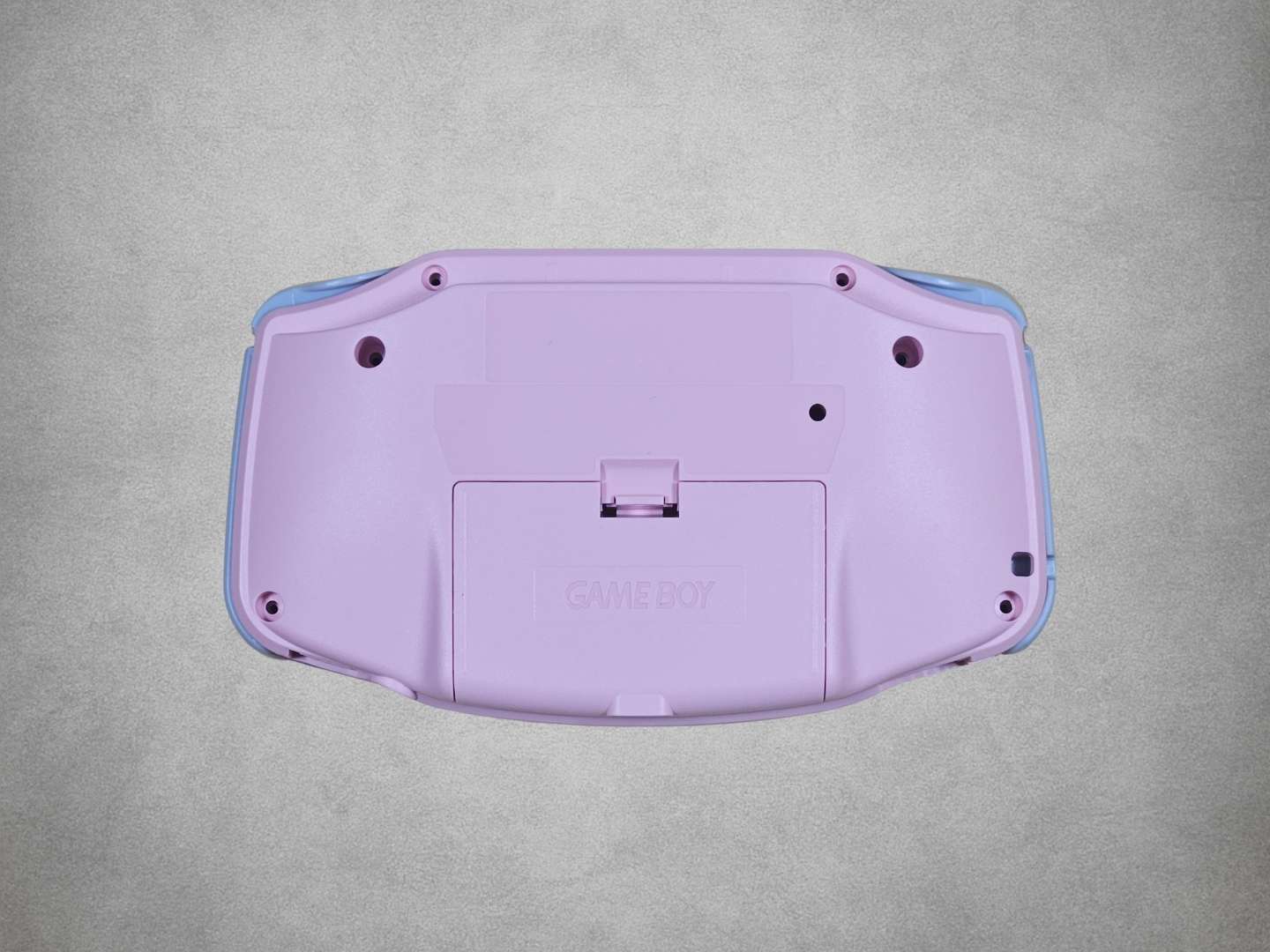 Pink Game Boy Advance shell on grey background back