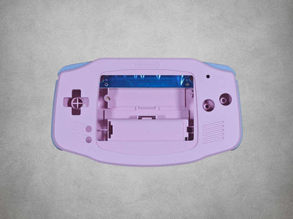 Pink Game Boy Advance shell on grey background