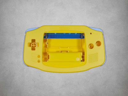 Yellow Game Boy Advance shell on grey background