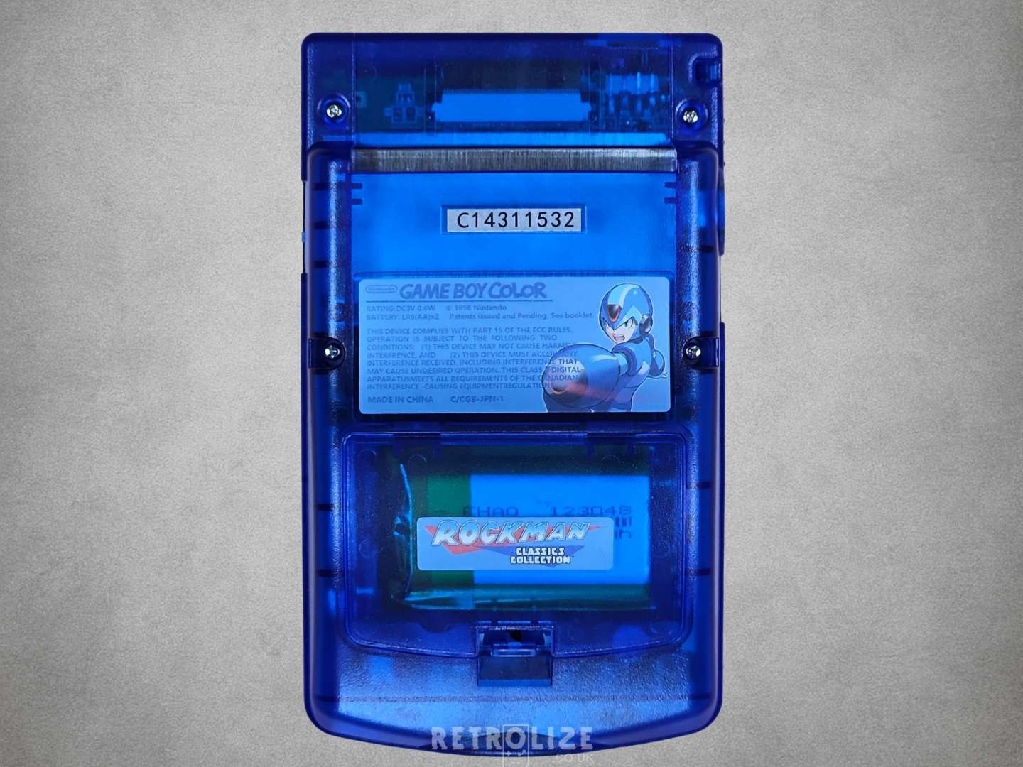 Game Boy Color with Mega Man design on a grey background back view