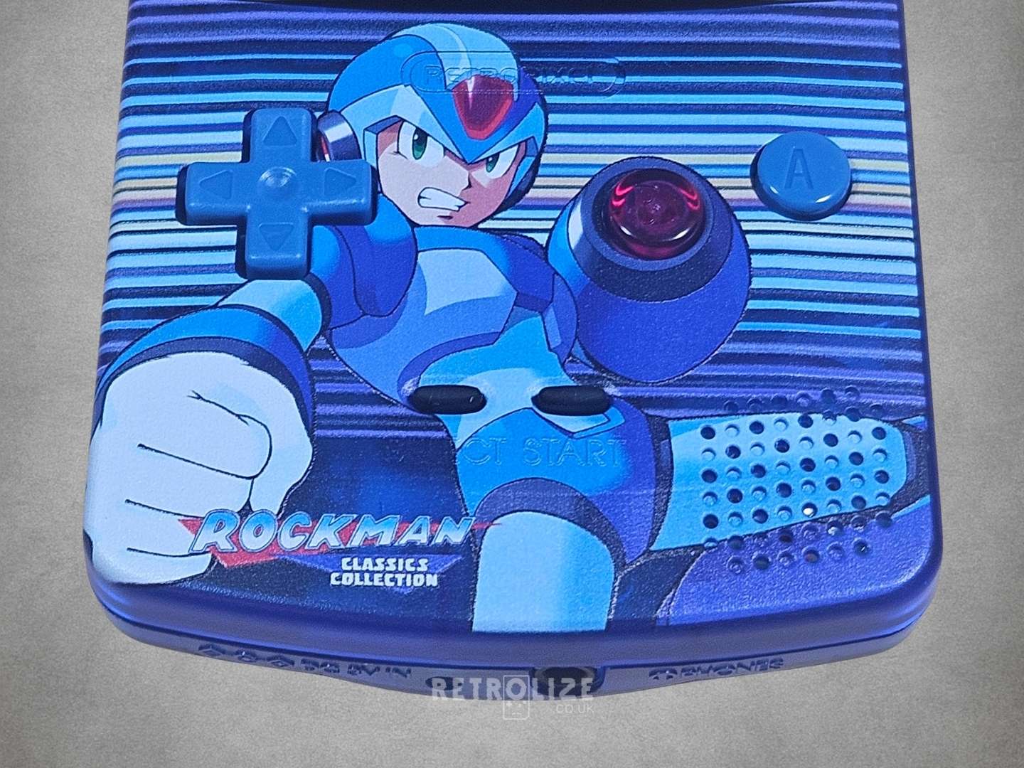 Game Boy Color with Mega Man design on a grey background
