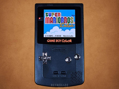 Black Game Boy Color OLED with Metallic Silver Buttons With Super Mario Bros on the screen