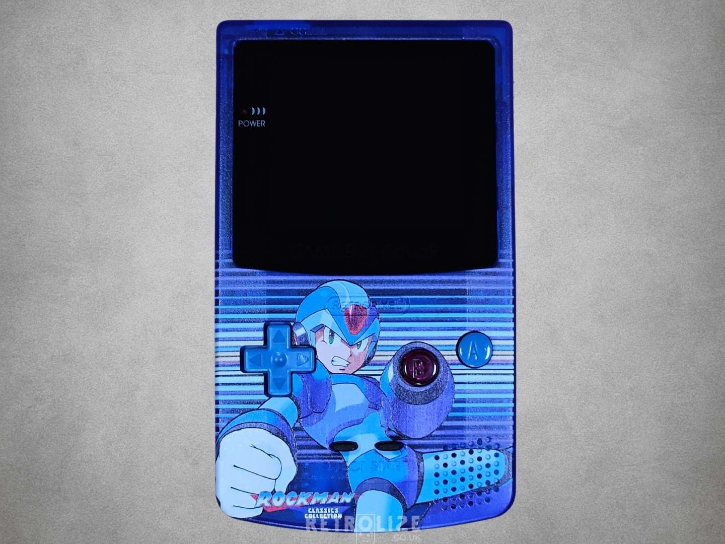 Game Boy Color with Mega Man design on a grey background