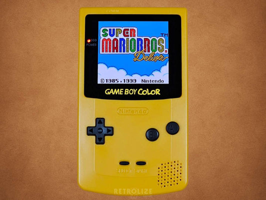 Yellow Dandelion Game Boy Color OLED with Black Buttons with Super Mario Bros Deluxe on the Screen