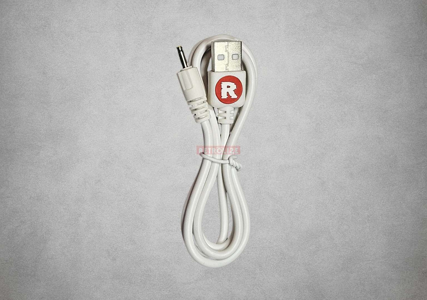White Game boy Color/Pocket USB cable with a red 'R' logo on a gray background