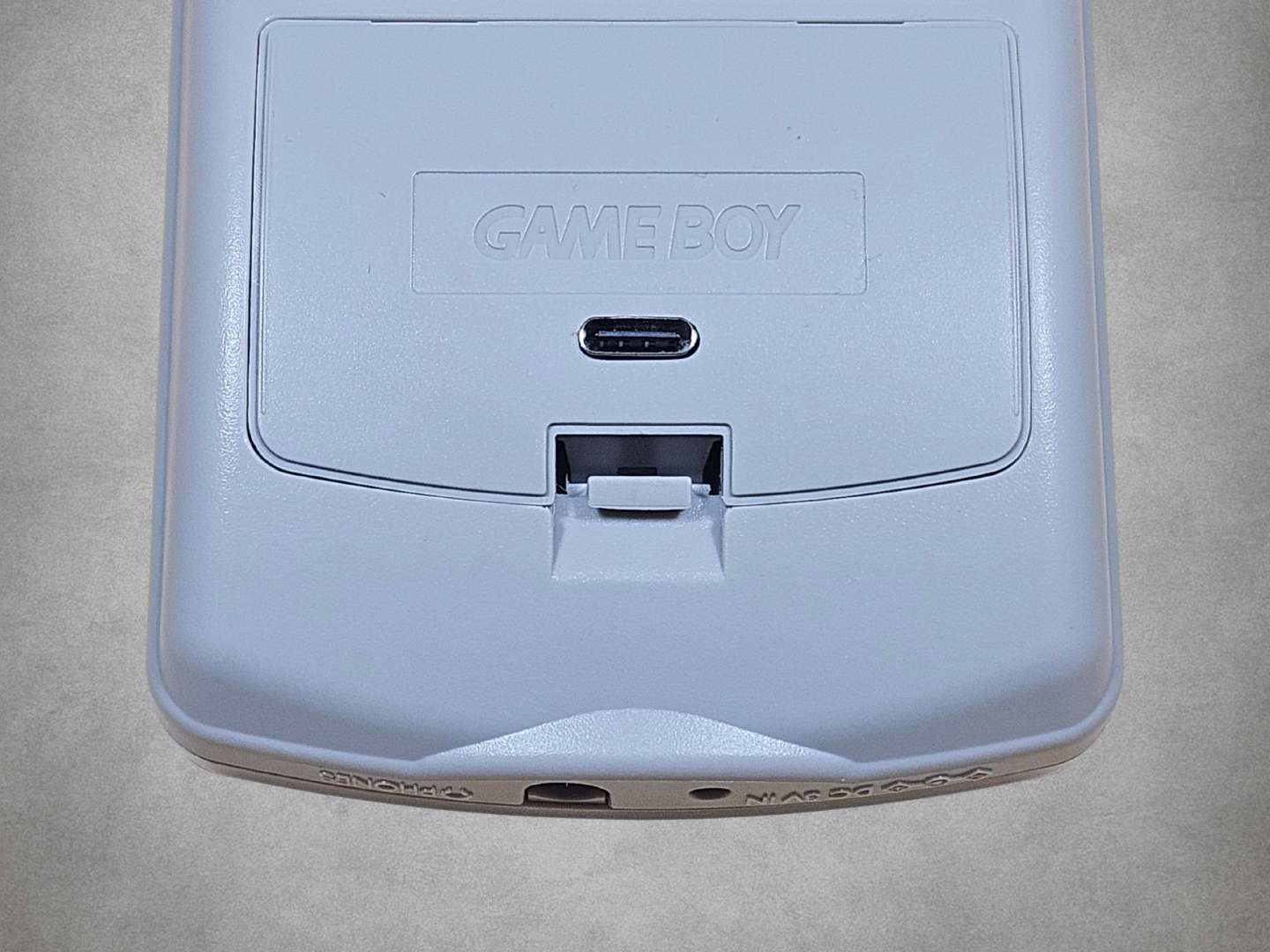 Grey Game Boy Color IPS upgrade kit Battery door on on grey background