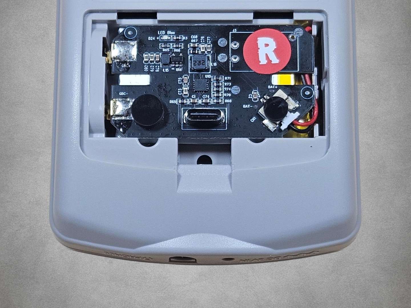 Grey Game Boy Color IPS upgrade kit battery view on grey background