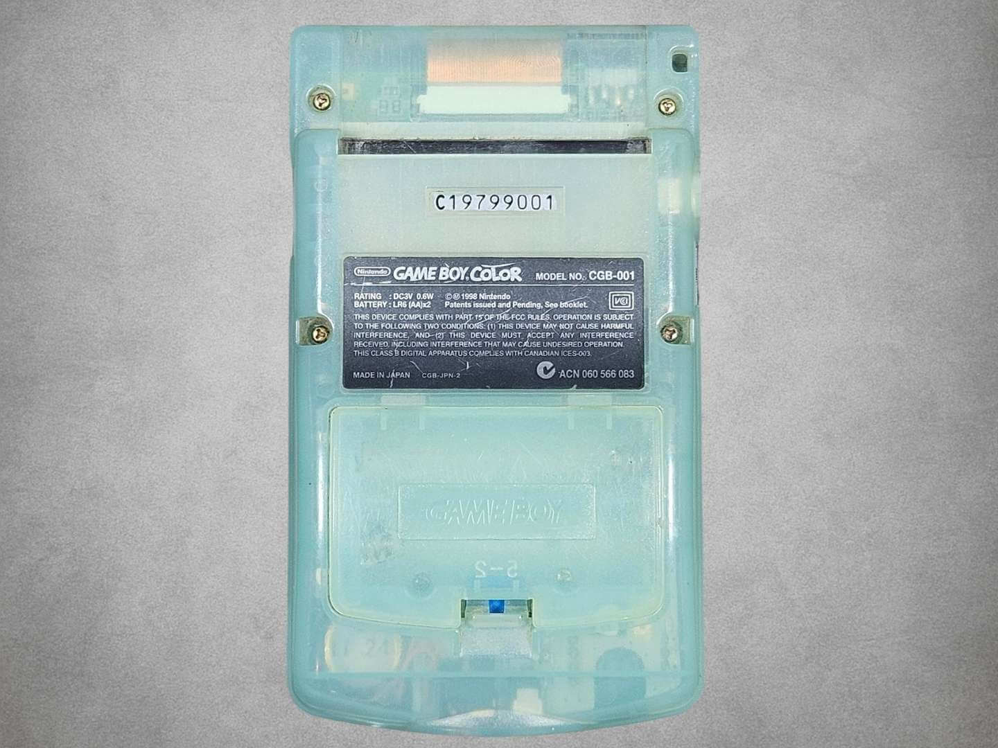 Japan Exclusive Ice Blue Game Boy Color back view on a gray background