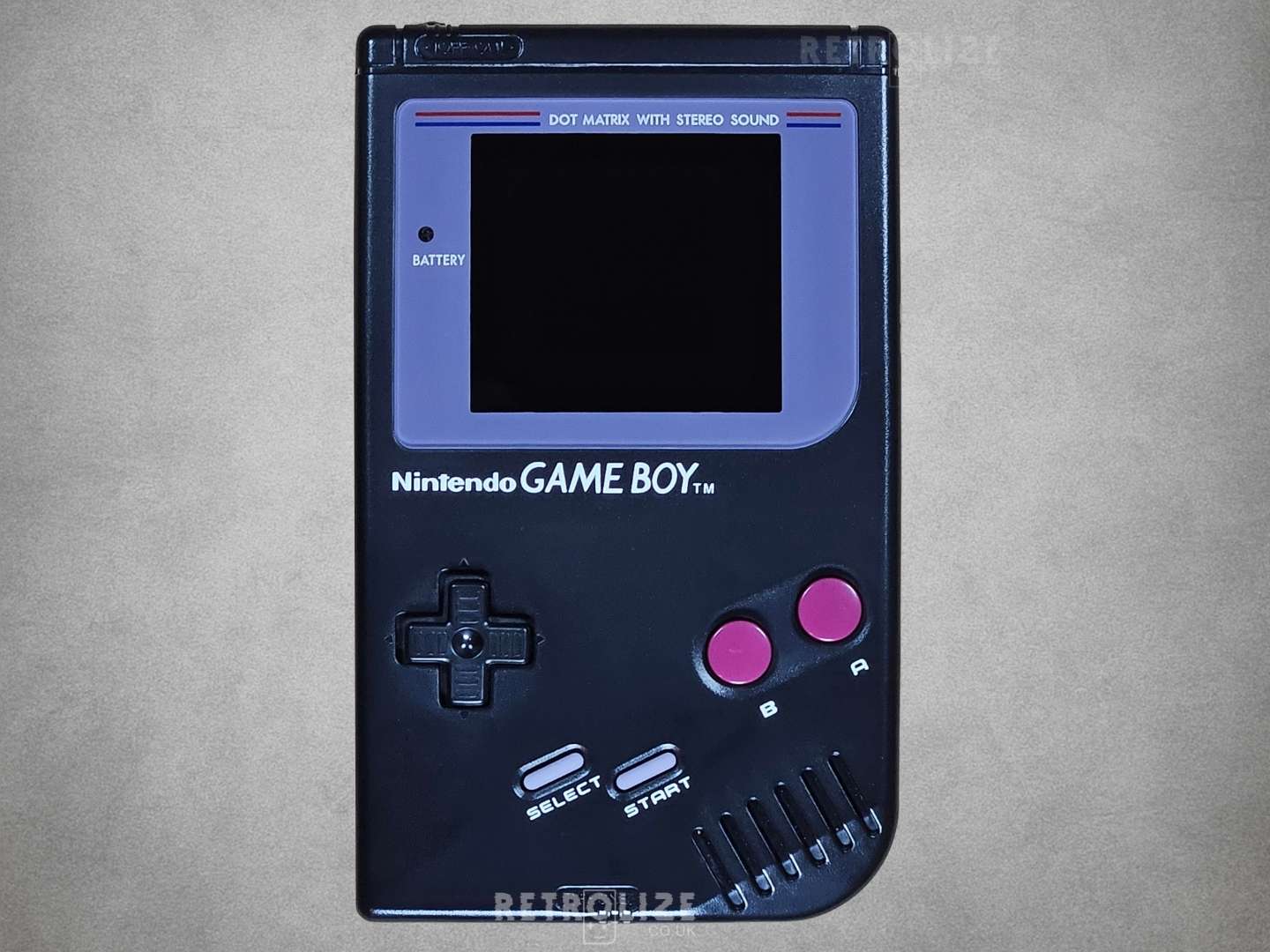 Black Game Boy DMG-01 screen off on grey background