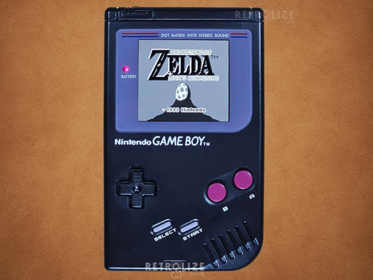 Black Nintendo Game Boy DMG-01 displaying The Legend of Zelda on a brown background