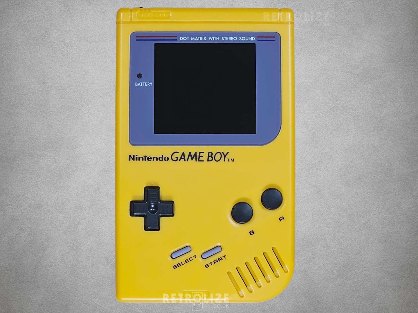 Yellow Game Boy DMG-01 screen off on grey background