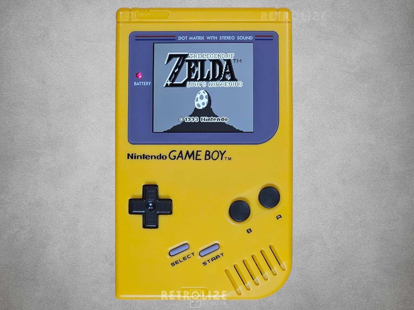 Yellow Game Boy DMG-01 screen showing Legend of Zelda Links Awakening on grey background