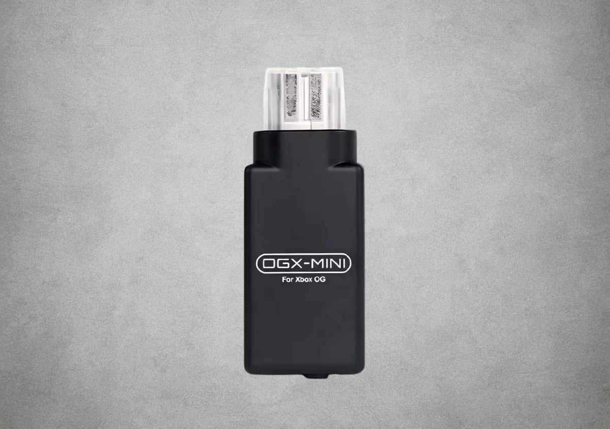 Front view of the black OGX Mini original Xbox Bluetooth controller adapter on a grey background