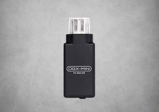 Front view of the black OGX Mini original Xbox Bluetooth controller adapter on a grey background