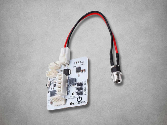 BitFunx SaturnPSU replacement board for Sega Saturn with attached power cable and DC barrel input socket.